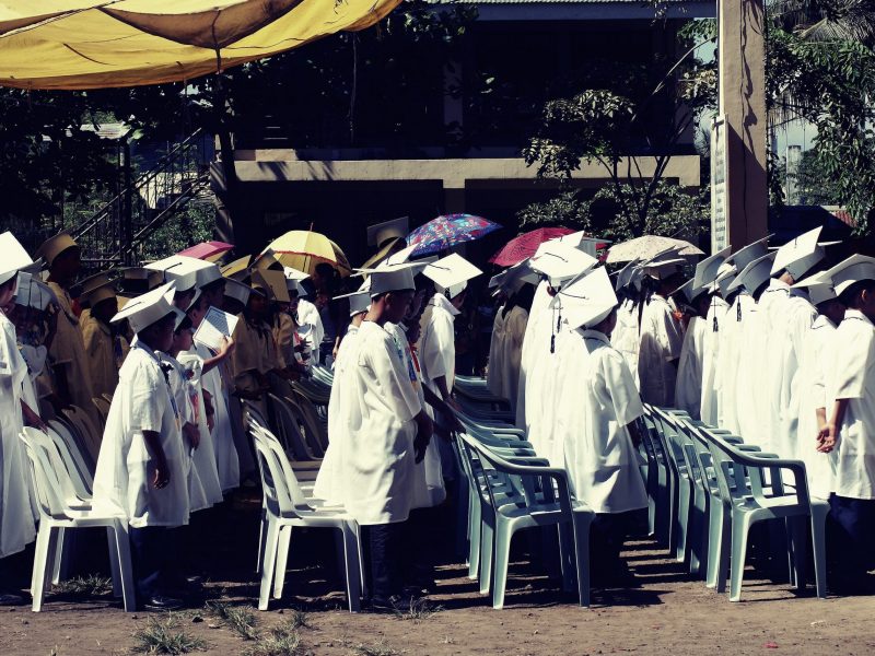 children-wearing-white-academic-gown-during-graduation-951289